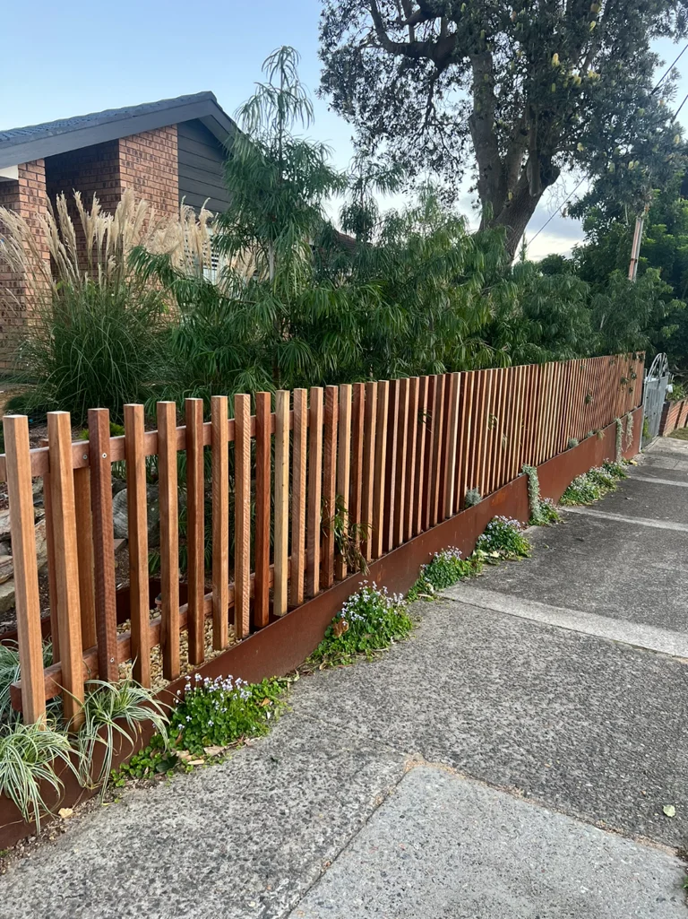 Timber slat fencing framing the planted Brook front garden