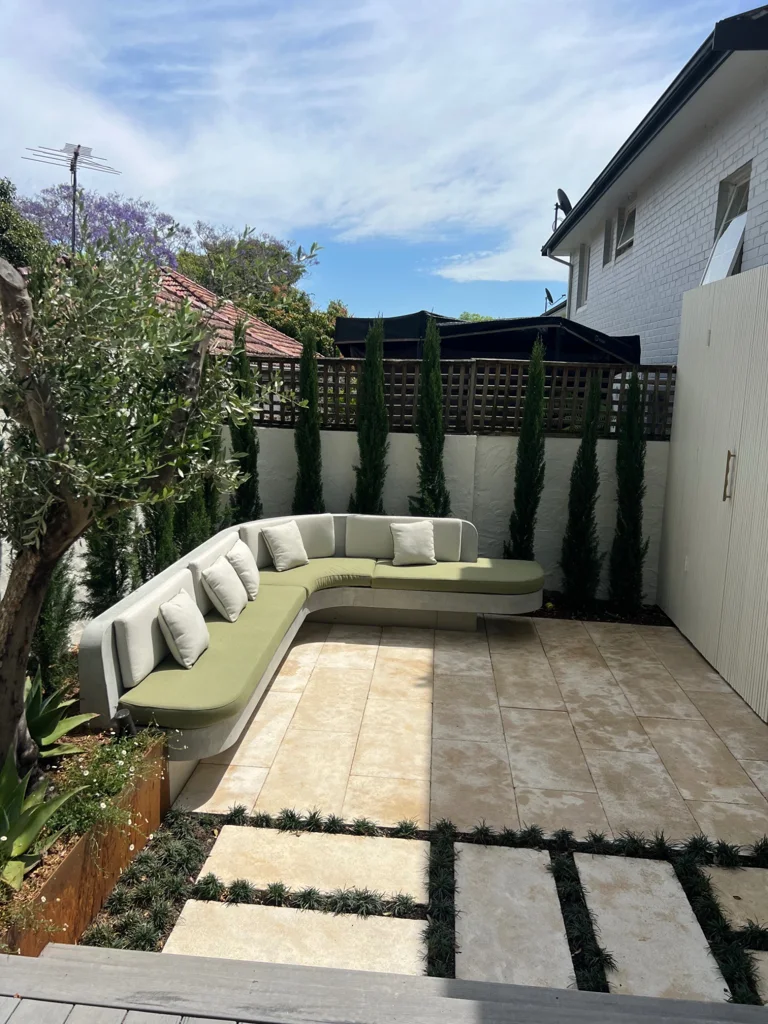Hunters Hill courtyard with pale paving, planted joints and wraparound seating