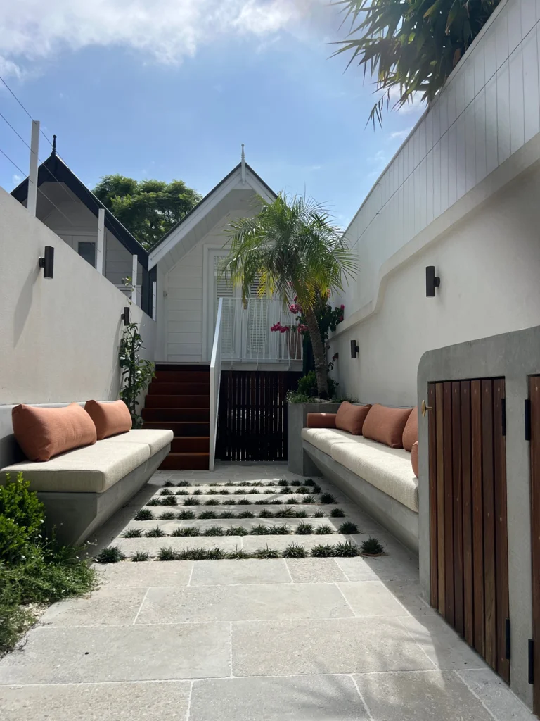 Paddo courtyard with planted paving joints, built-in seats and terracotta cushions
