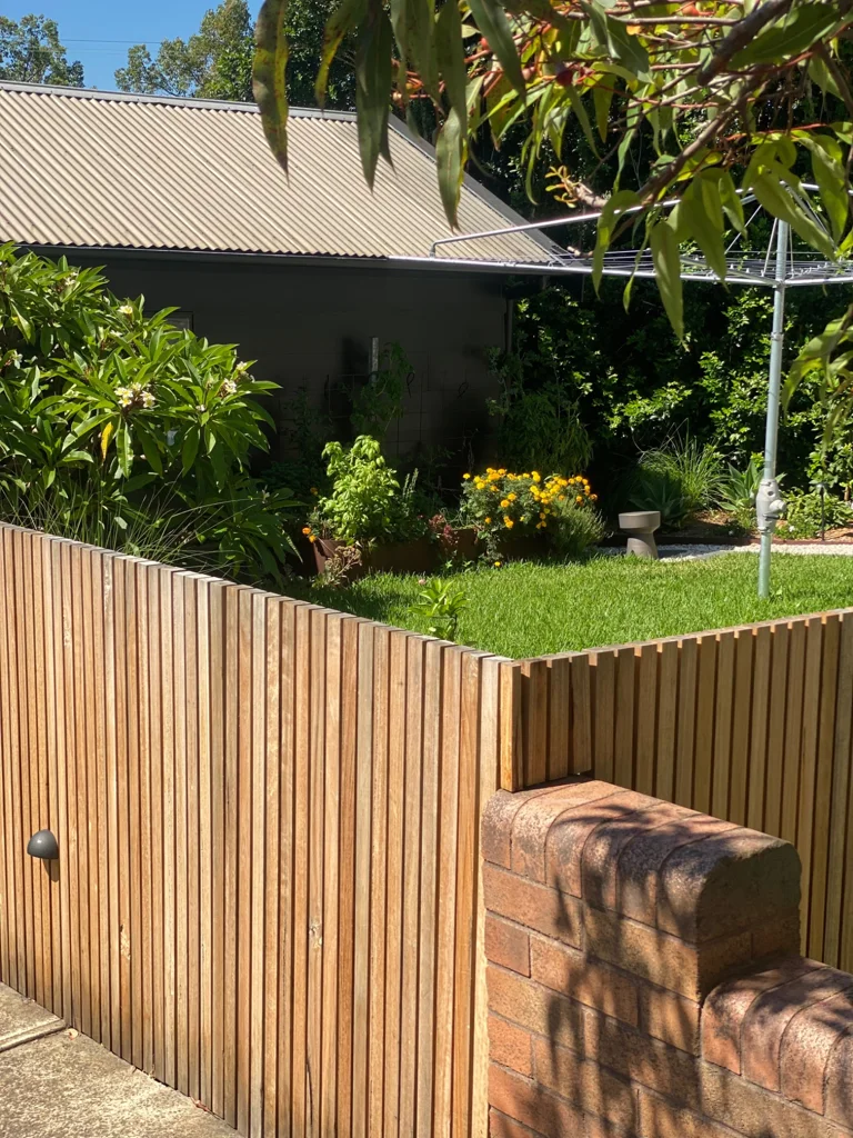 Timber slat fencing enclosing a planted front garden