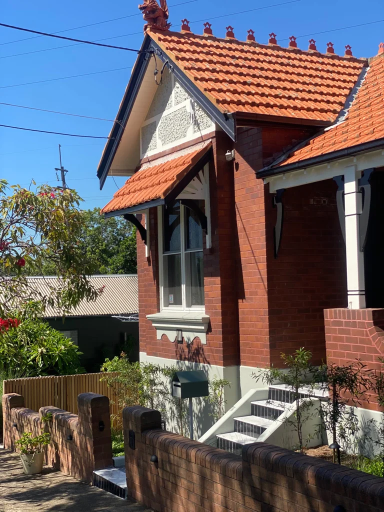 Brick facade and tiled entrance steps at Wilga House