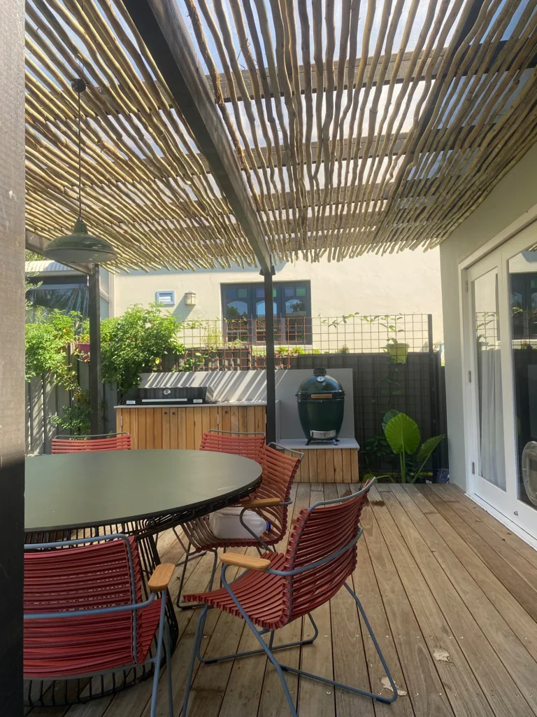 Slatted pergola shading the timber deck and outdoor dining area