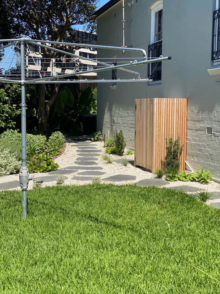 Lawn and a stepping stone path beside timber fencing